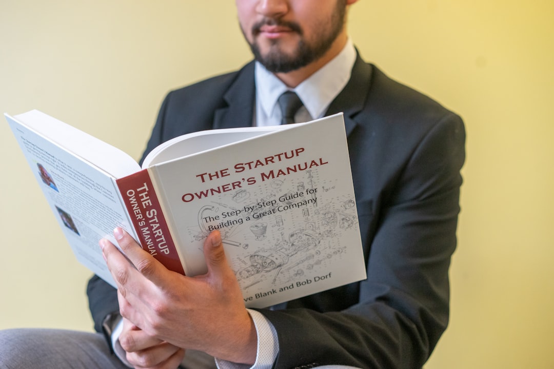 a-man-in-a-suit-is-reading-a-book-gu6e6s1mmru